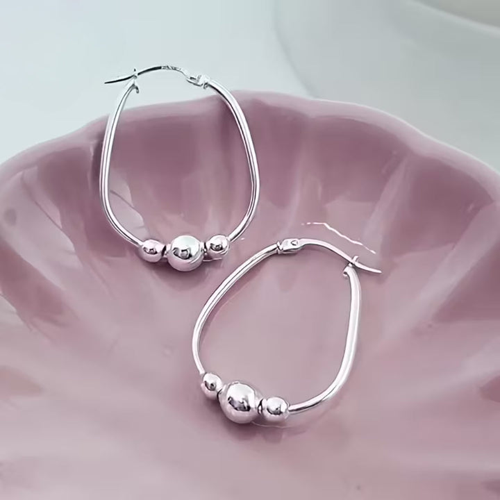 Boucles d'oreilles créoles en perles argentées